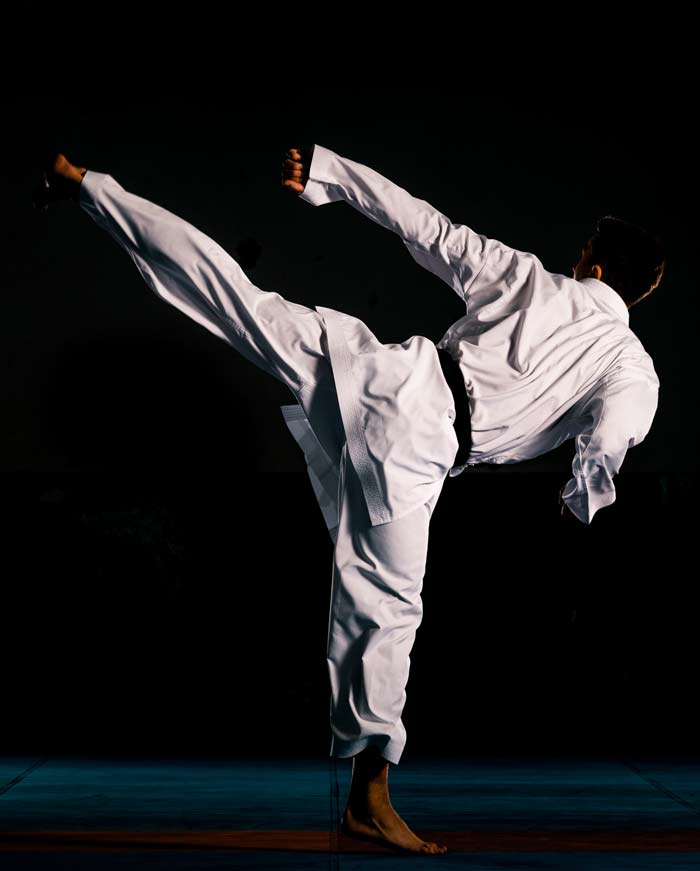 young man performing a karate kick
